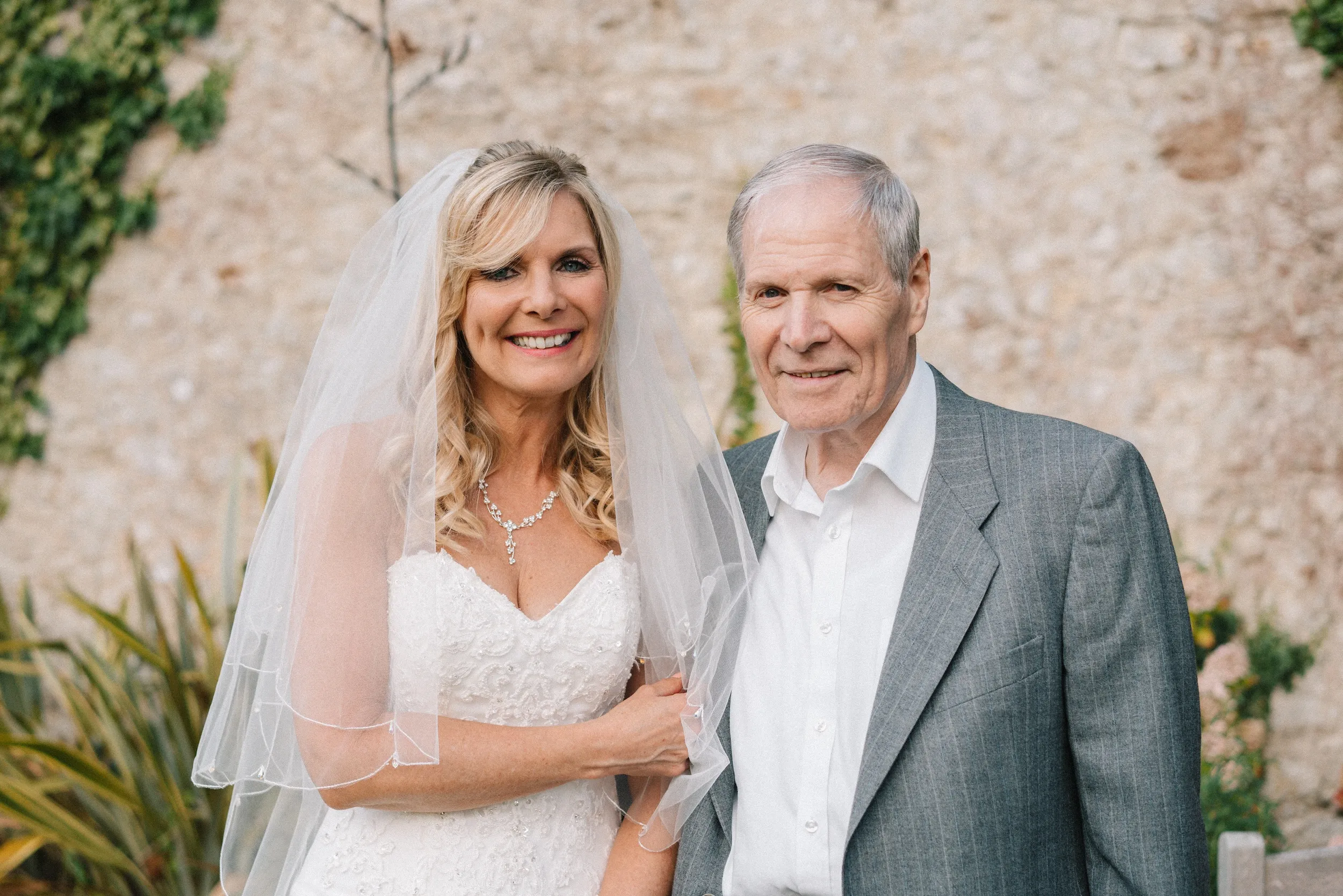 Fiona with her father against the old stone wall of the garden