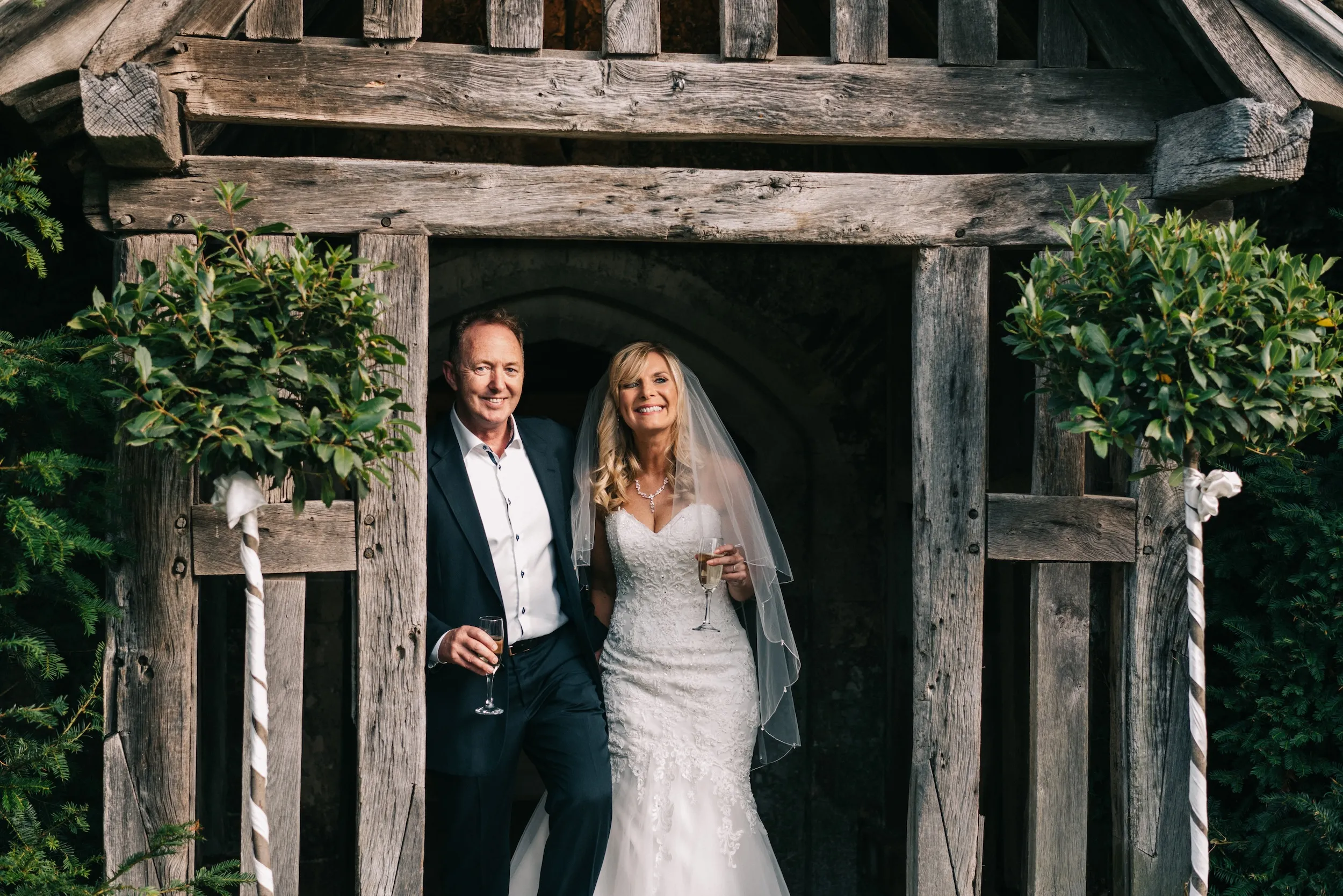 Mark and Fiona step out of the old timber porch at Bilsington Priory