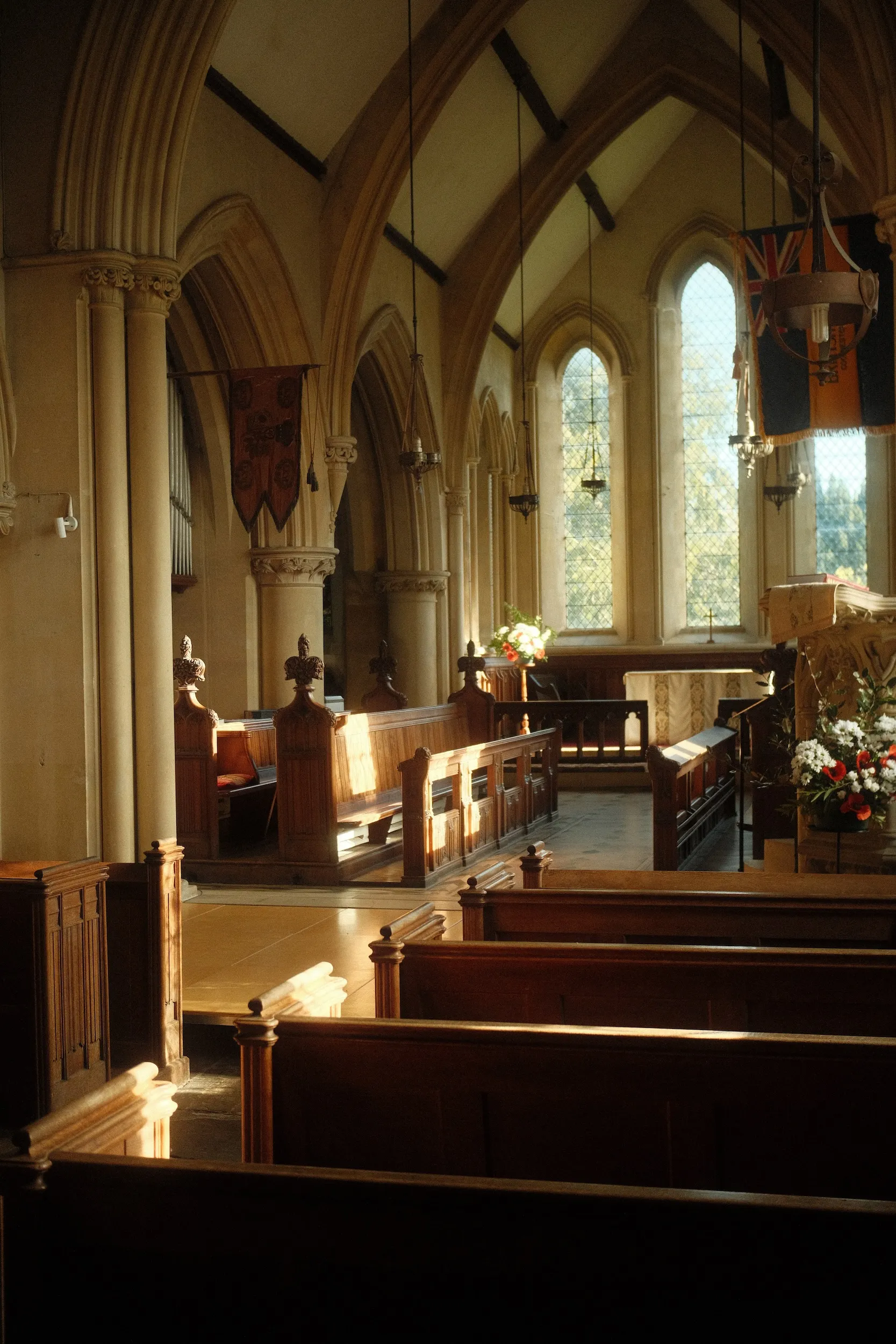 Evening sunlight falling across wooden pews inside a Kent church