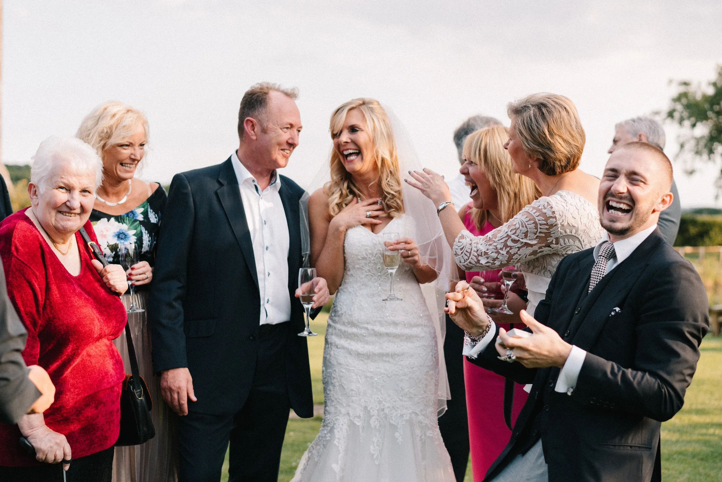 Mark, Fiona and their family laughing together on the lawn
