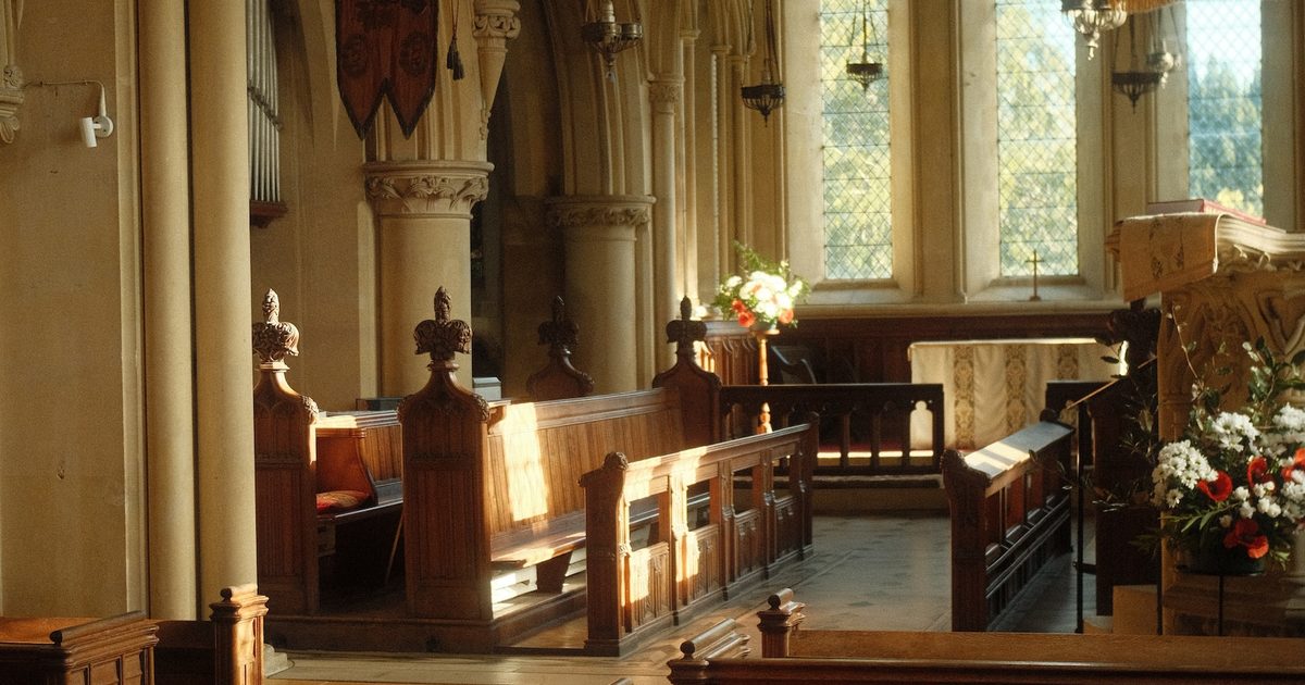Evening light across wooden pews inside a Kent church